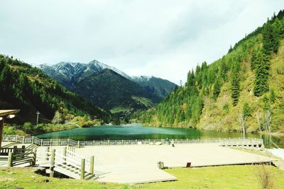 Scenic view of lake and mountains against sky