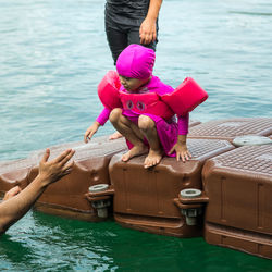 Full length of woman floating on lake