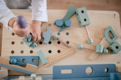 High angle view of child playing on table