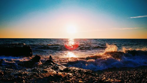 Scenic view of sea against clear sky during sunset