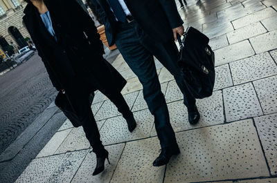 Low section of people standing on tiled floor