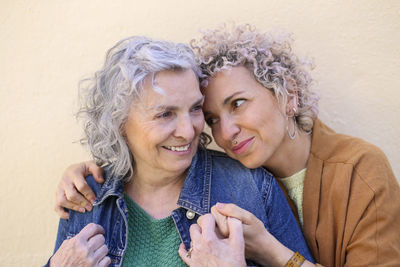 Portrait of a senior mother with her adult daughter embracing outdoors