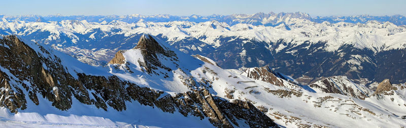 Winter aerial wide angle panorama of snowed alps in sunny austria