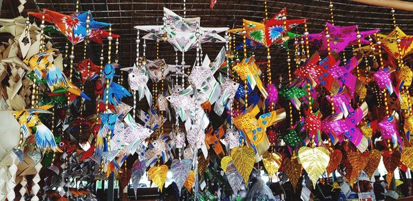 Multi colored decorations hanging in store for sale in market