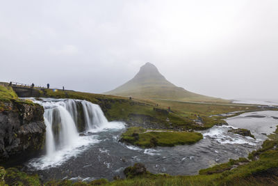 Scenic view of waterfall against sky