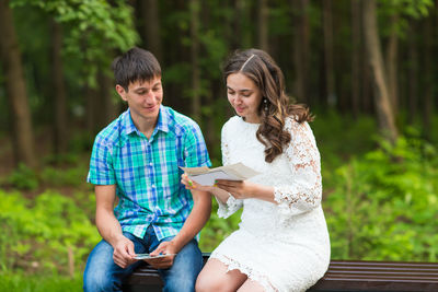 Young couple sitting on mobile phone