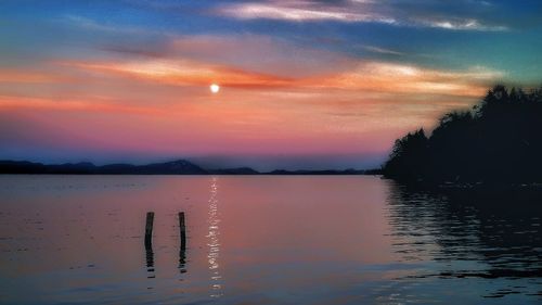 Scenic view of lake against sky during sunset