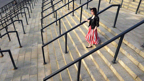High angle view of woman standing on staircase