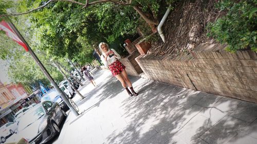 People walking on road amidst trees