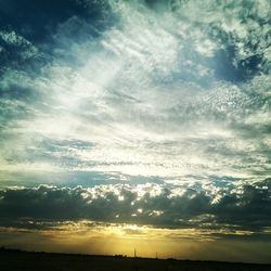 Scenic view of landscape against cloudy sky