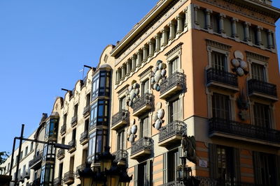 Low angle view of residential building against blue sky