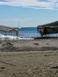 Scenic view of sandy beach against sky