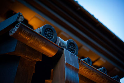 Low angle view of cross on roof against japanese old style building