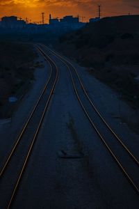 High angle view of railroad tracks by road against sky