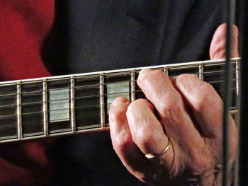 Cropped image of musician playing guitar