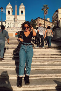 Full length of friends on staircase outside building