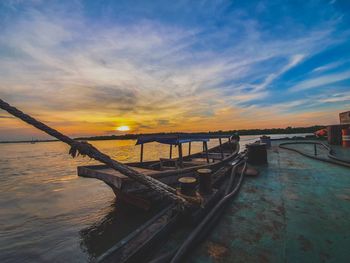 Pier over sea against sky during sunset