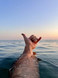 Low section of woman swimming in sea