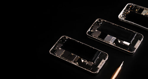 Close-up of mobile phone against black background