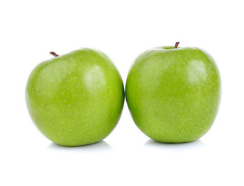 Close-up of green apple against white background