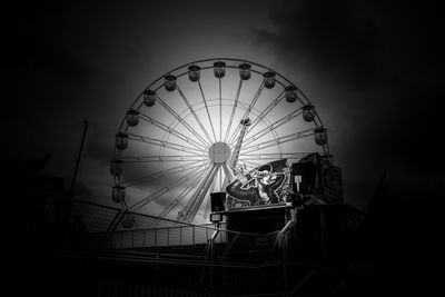 Low angle view of ferris wheel at night