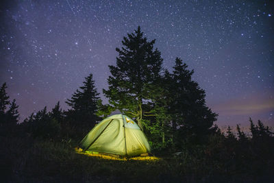 Tent on field against sky at night