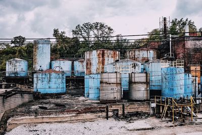 Abandoned building against cloudy sky