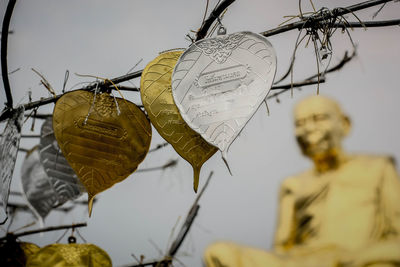 Close-up of decoration hanging against sky