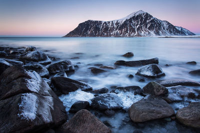 Rocks on beach against sky