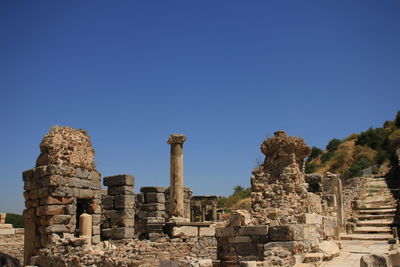 Low angle view of old ruins against clear blue sky at ephesus 