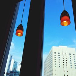 Low angle view of illuminated street light against sky