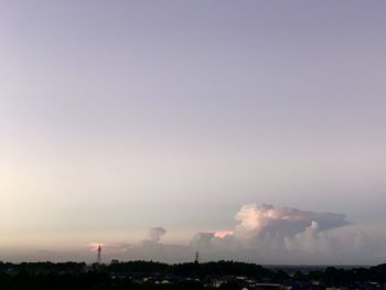 Smoke emitting from factory against sky during sunset