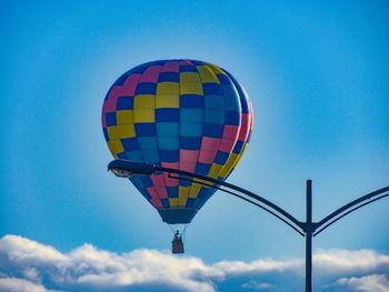 Low angle view of hot air balloon against blue sky