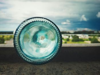 Close-up of camera against sky