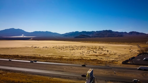 Scenic view of desert against blue sky