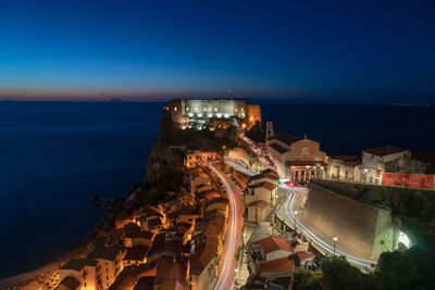 High angle view of illuminated buildings at seaside