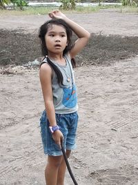 Portrait of teenage girl standing on land