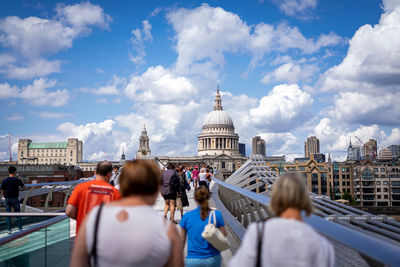 Rear view of people in front of cityscape