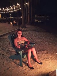 Portrait of young woman sitting on ground