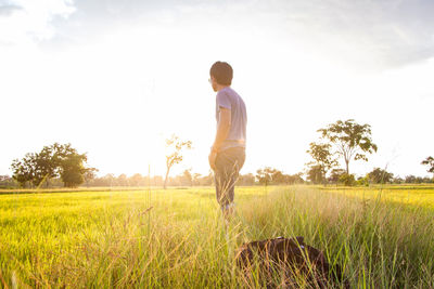 Man standing on field against sky