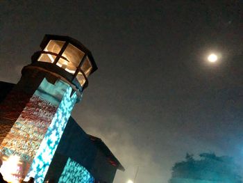 Low angle view of illuminated tower against sky at night