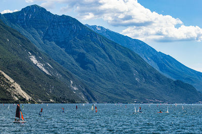 Scenic view of sea and mountains against sky