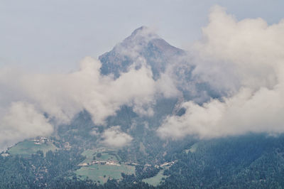 Aerial view of mountain range against cloudy sky