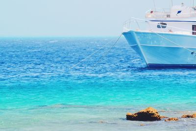 Sailboat in sea against sky