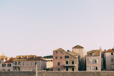 Low angle view of buildings in town against sky