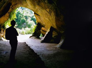 Rear view of man standing in tunnel