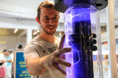 Young man touching innovative object