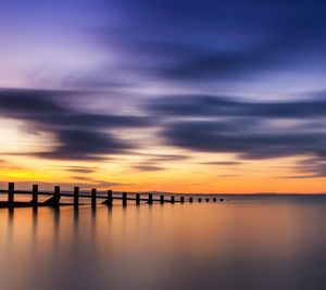 Scenic view of dramatic sky over sea during sunset