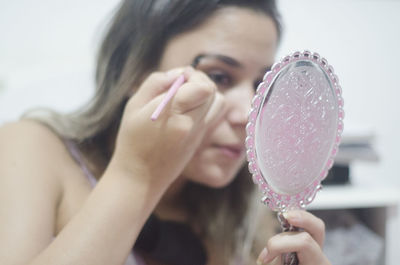 Close-up of woman holding bubbles