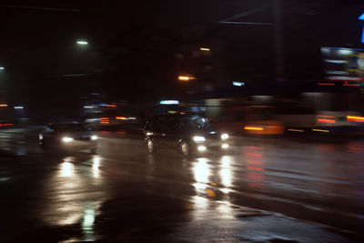 Cars on wet street at night